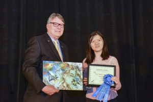 Quanjie Dai with her blue ribbon for winning the 2019 Texas Aviation Arts Contest.