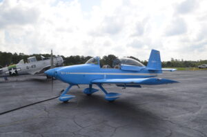 A blue aircraft parked on a tarmac.